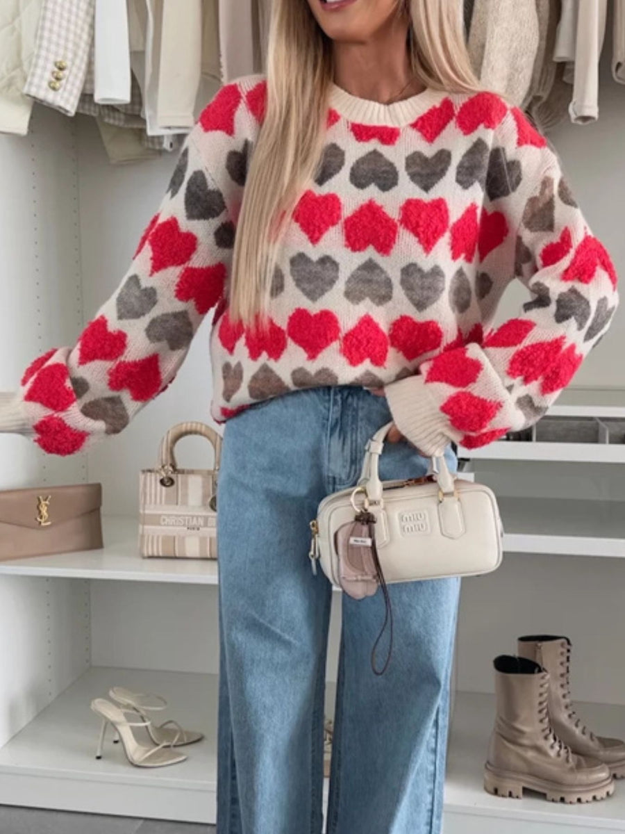 red pullover sweater featuring ribbed cuffs and heart-print