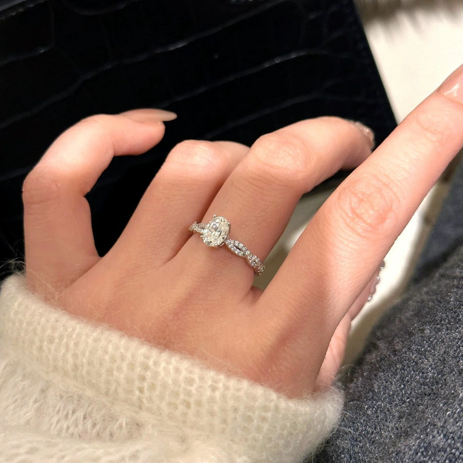 Moissanite oval ring in sterling silver with a twisted band.