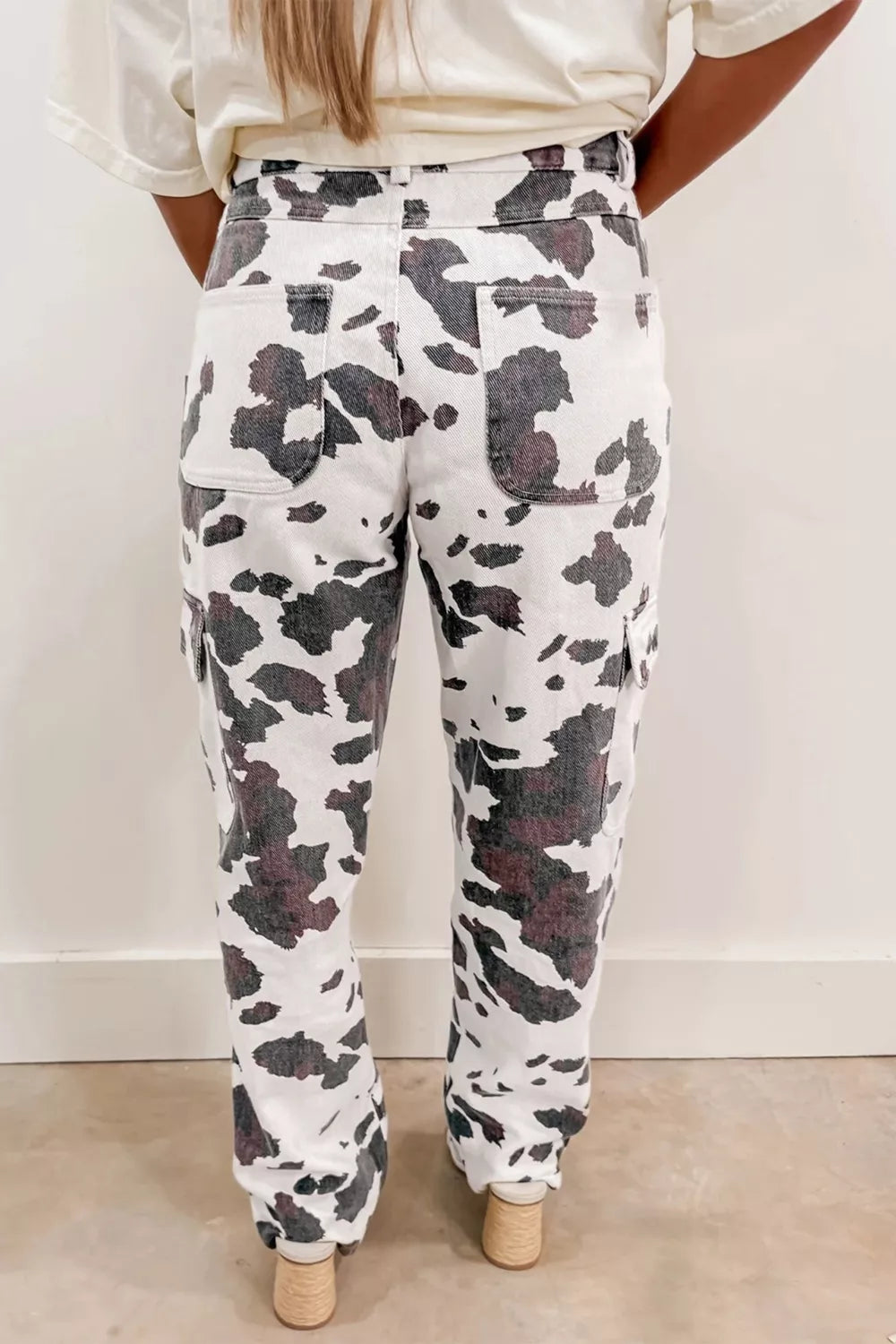 Cow print utility jeans with cargo pockets and a comfortable cotton blend.