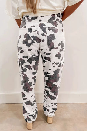Cow print utility jeans with cargo pockets and a comfortable cotton blend.