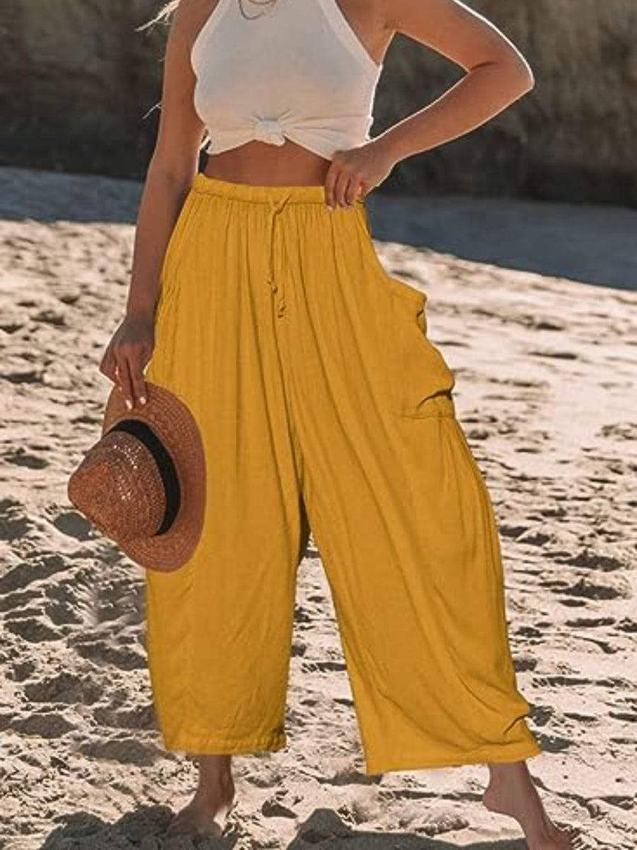 Mustard linen balloon pants with sculptural pockets and drawstring waist.