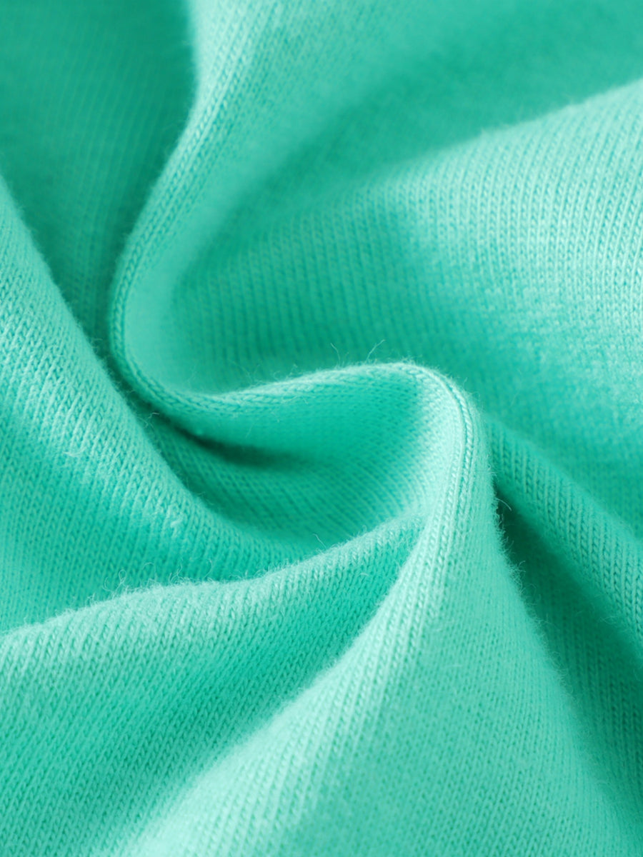 Close up of soft teal cotton fabric with visible knit texture.