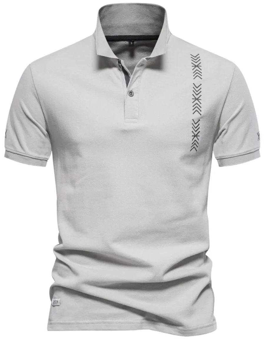 Gray piqué polo shirt with chevron embroidery detail on the chest and sleeve.