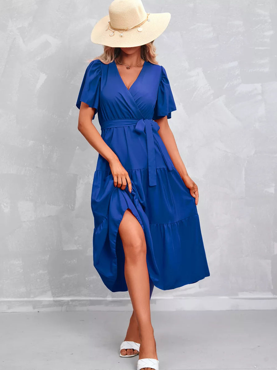 Royal blue tiered midi dress with flutter sleeves, V-neck, and belted waist.
