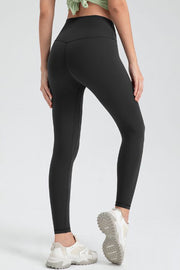 Black high-waist performance leggings with sculpted seams and a V-cut back detail.