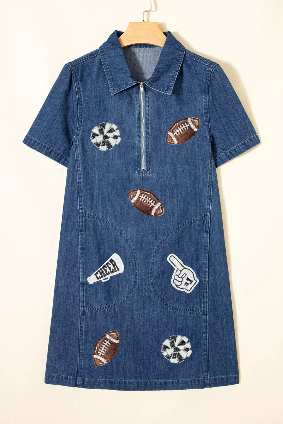 Denim mini dress in dark blue with football and cheer patches, short sleeves, collar, and zip front.