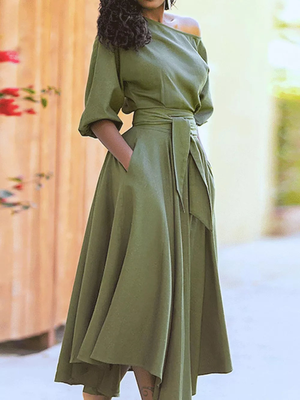 Off-the-shoulder belted dress in Matcha Green with elbow-length sleeves and a flowing skirt.