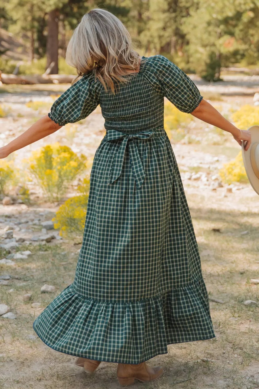 Green plaid cotton maxi dress with smocked bodice, puff sleeves, tie waist, and ruffled hem.