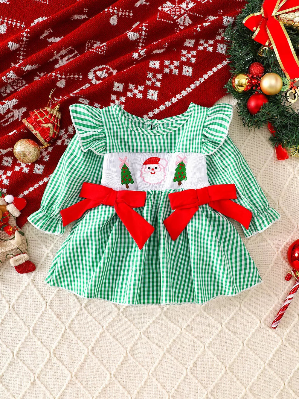Green gingham baby dress with Santa embroidery and red bows.