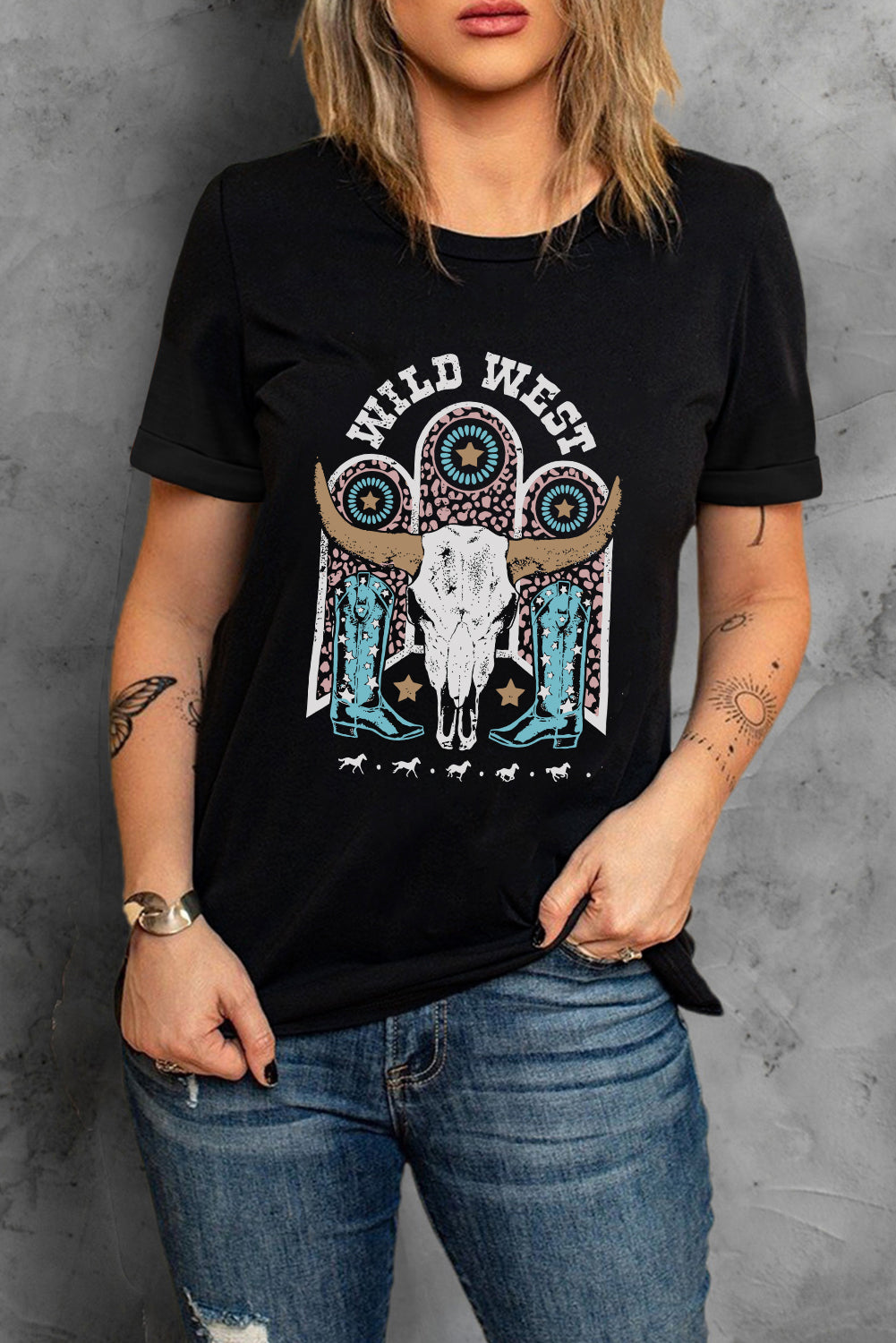 Black crewneck tee with Wild West graphic featuring bull skull and cowboy boots.