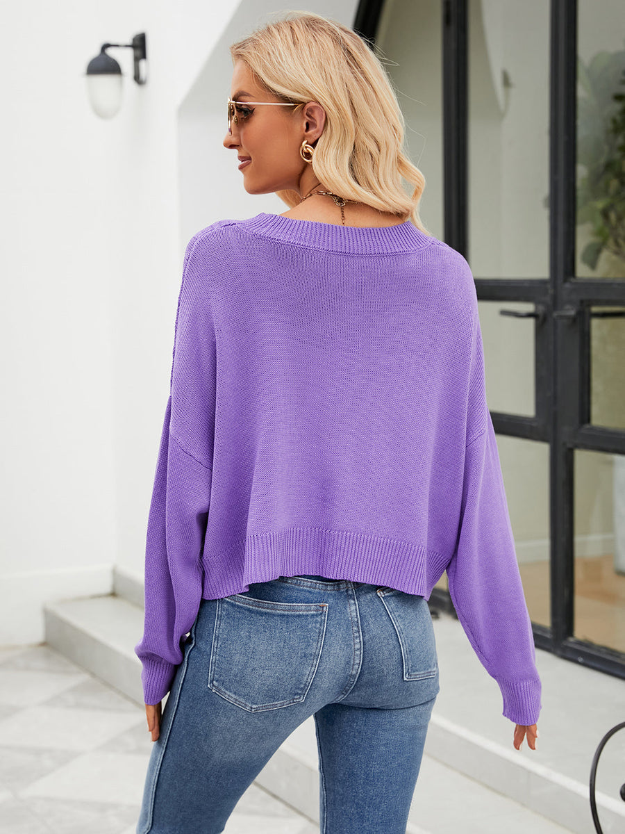 Purple cropped V-neck knit cardigan with ribbed hem and cuffs.