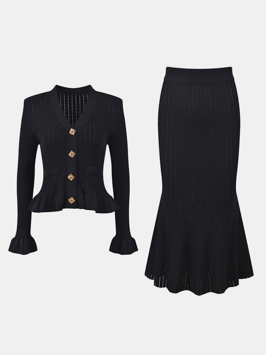 Black knit cardigan with ruffled hem and bell sleeves, paired with a matching midi skirt.