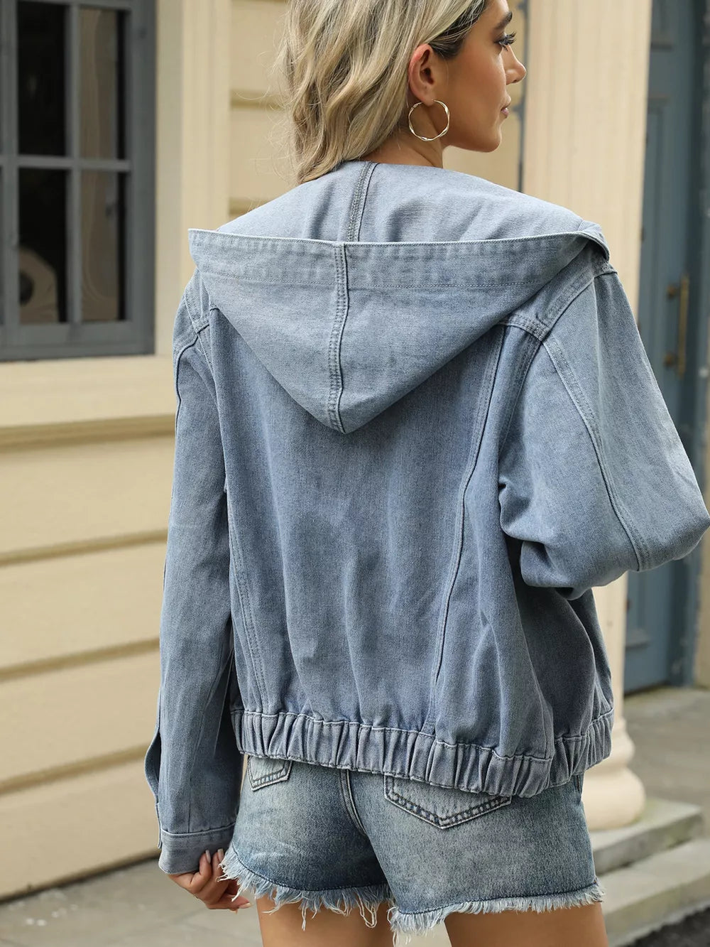 Blue denim hooded trucker jacket with elasticated hem and cuffs.