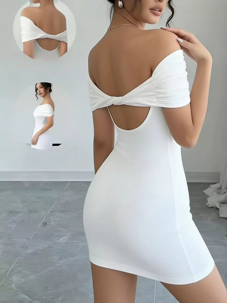 White backless bodycon mini dress with draped detail and off-the-shoulder sleeves.