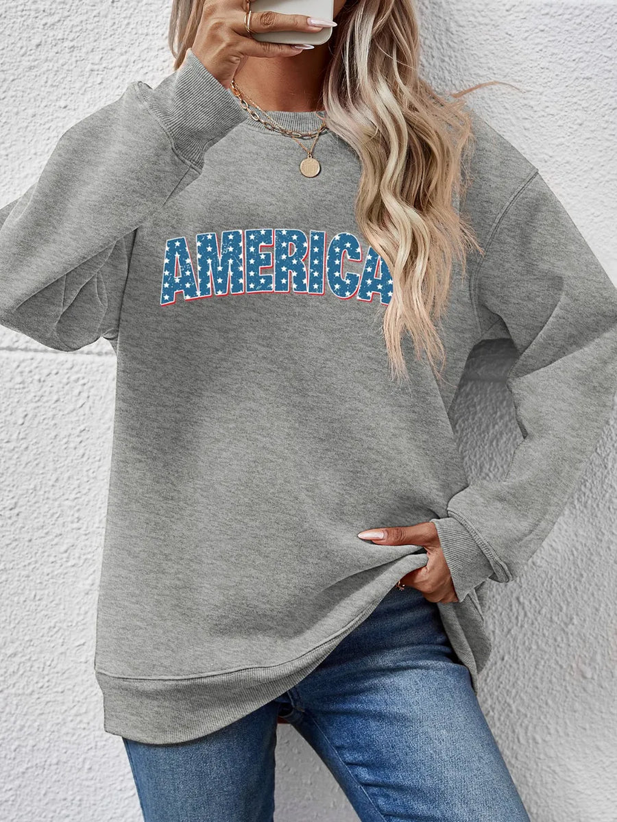 Grey crewneck sweatshirt with AMERICA graphic in stars and stripes pattern