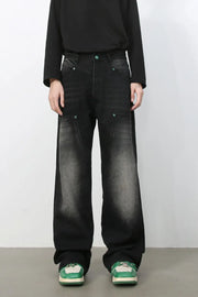 Faded wash wide-leg carpenter jeans in dark black with green button details.