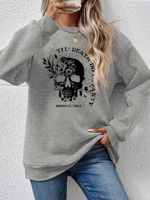 Gray raglan sweatshirt with floral skull graphic and text.
