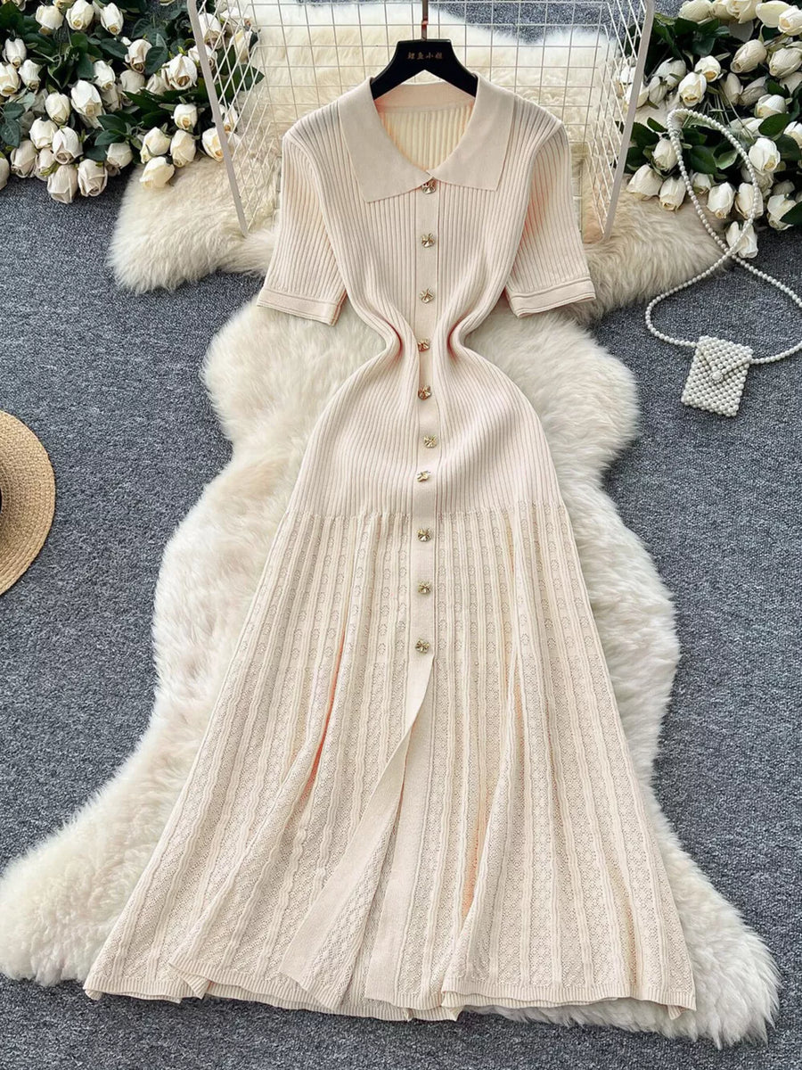 Apricot knit Peter Pan collar dress with gold buttons and a pleated skirt.