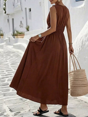 Brown V-neck sleeveless maxi dress with elastic waist and flowing skirt.