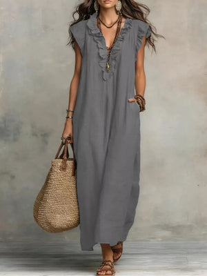 Gray ruffled V-neck maxi dress with pockets and short sleeves.