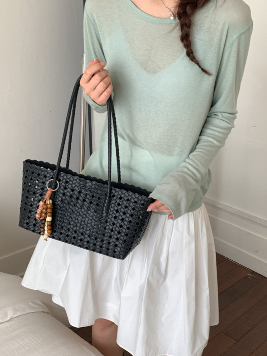 shoulder bag in black featuring woven design and boxy fit
