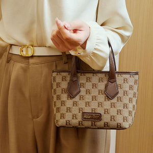 dark brown crossbody bag featuring top handles and monogram