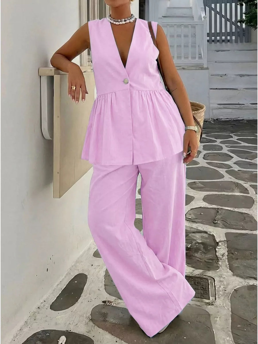 Pink V-neck sleeveless peplum top and wide-leg pants set with button detail.