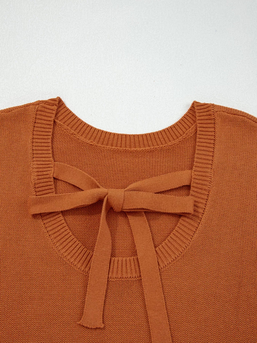 Caramel acrylic blend sweater with a tie bow detail at the back neckline.