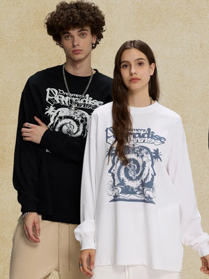 White long sleeve graphic t-shirt with bold blue "Dreamers Paradise" print and abstract design.