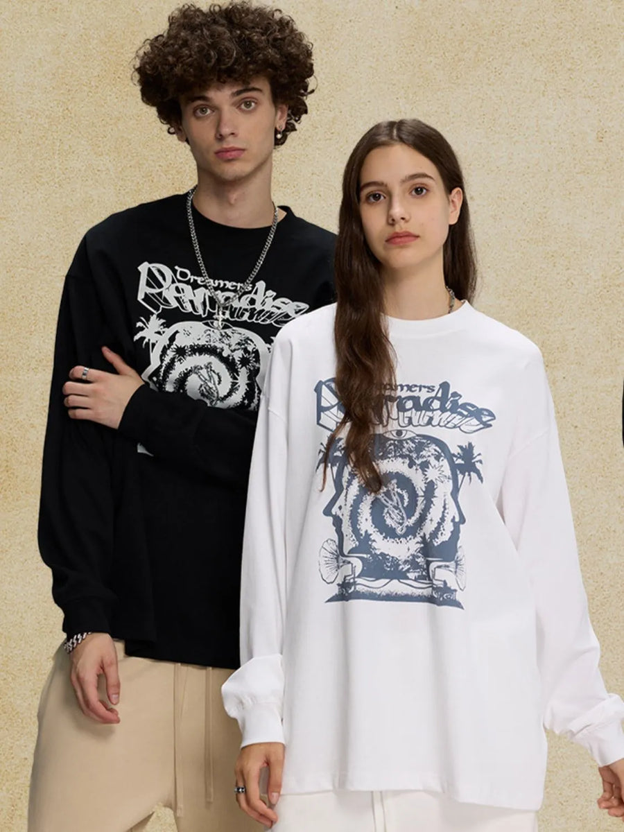 White long sleeve graphic t-shirt with bold blue "Dreamers Paradise" print and abstract design.