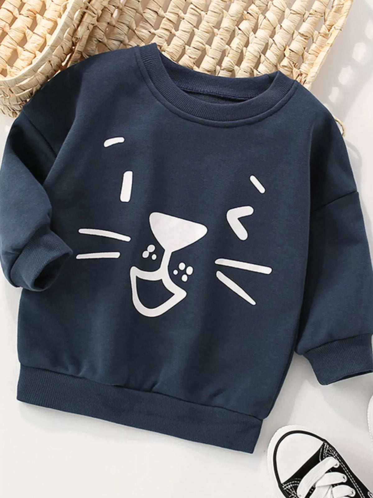 Dark navy crew-neck sweatshirt with a white cartoon cat face design, 100% cotton.