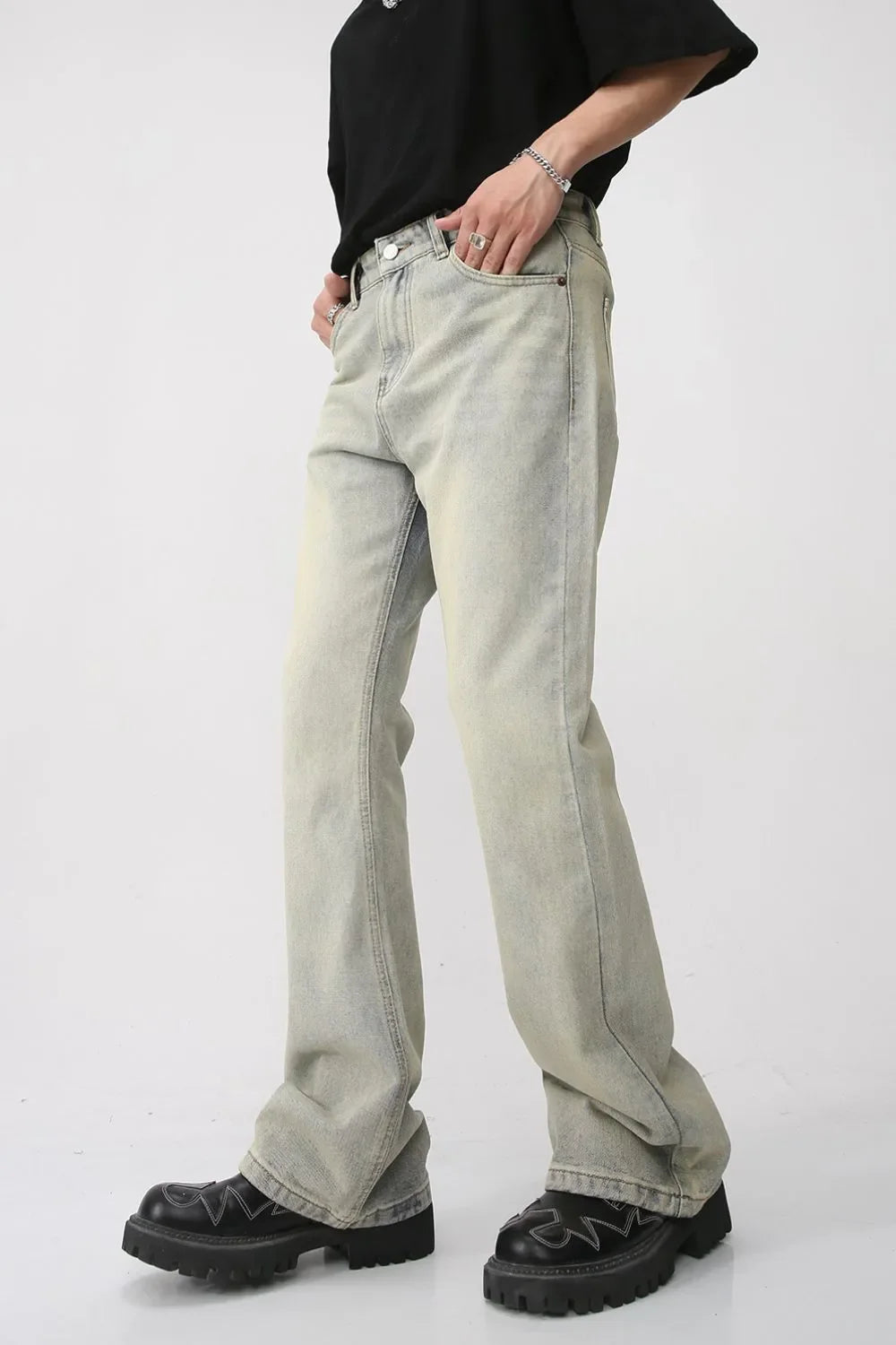 Light blue vintage wash flare denim trousers with a relaxed fit.