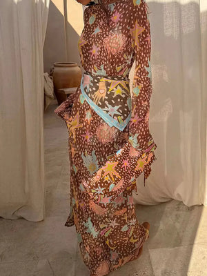 Brown celestial print maxi dress with a scarf belt and bell sleeves.