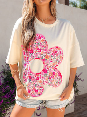 Cream oversized cotton t-shirt with a large floral chenille patch and crew neck.