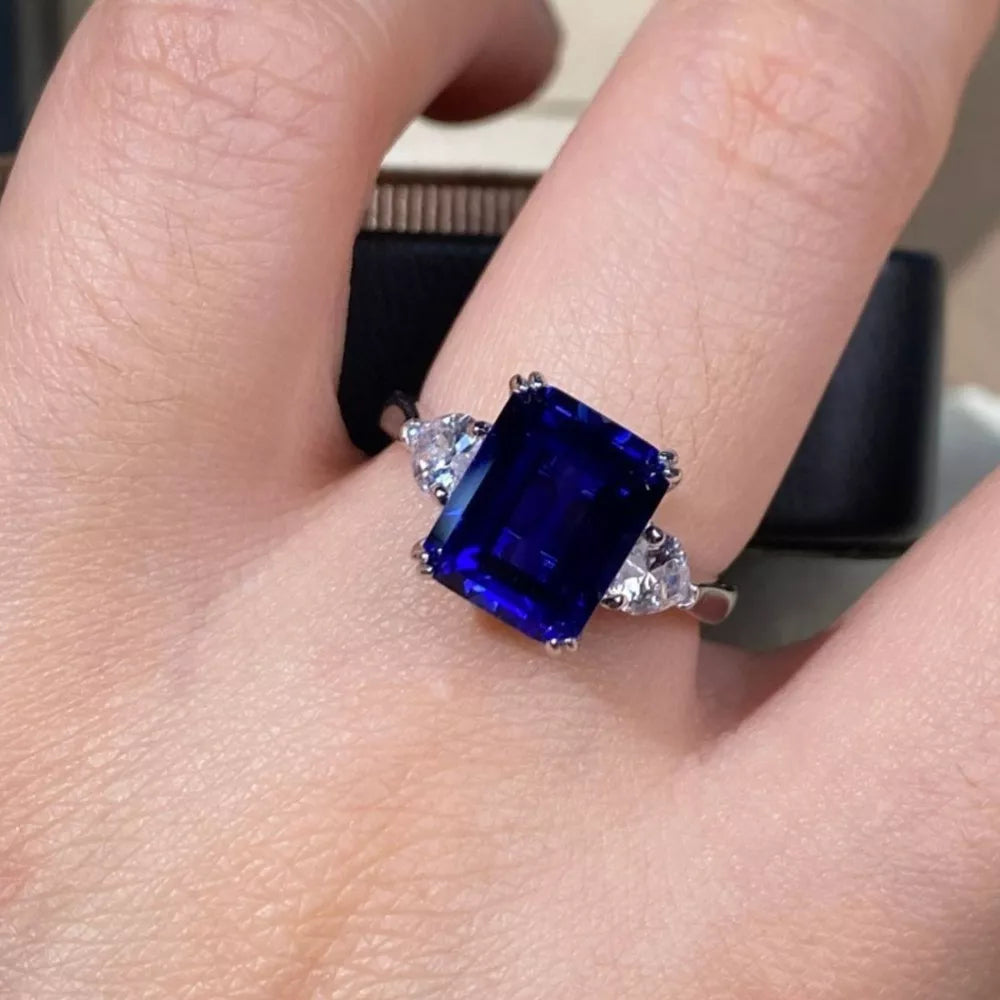 ring in sapphire blue featuring three-stone setting and three-stone fit
