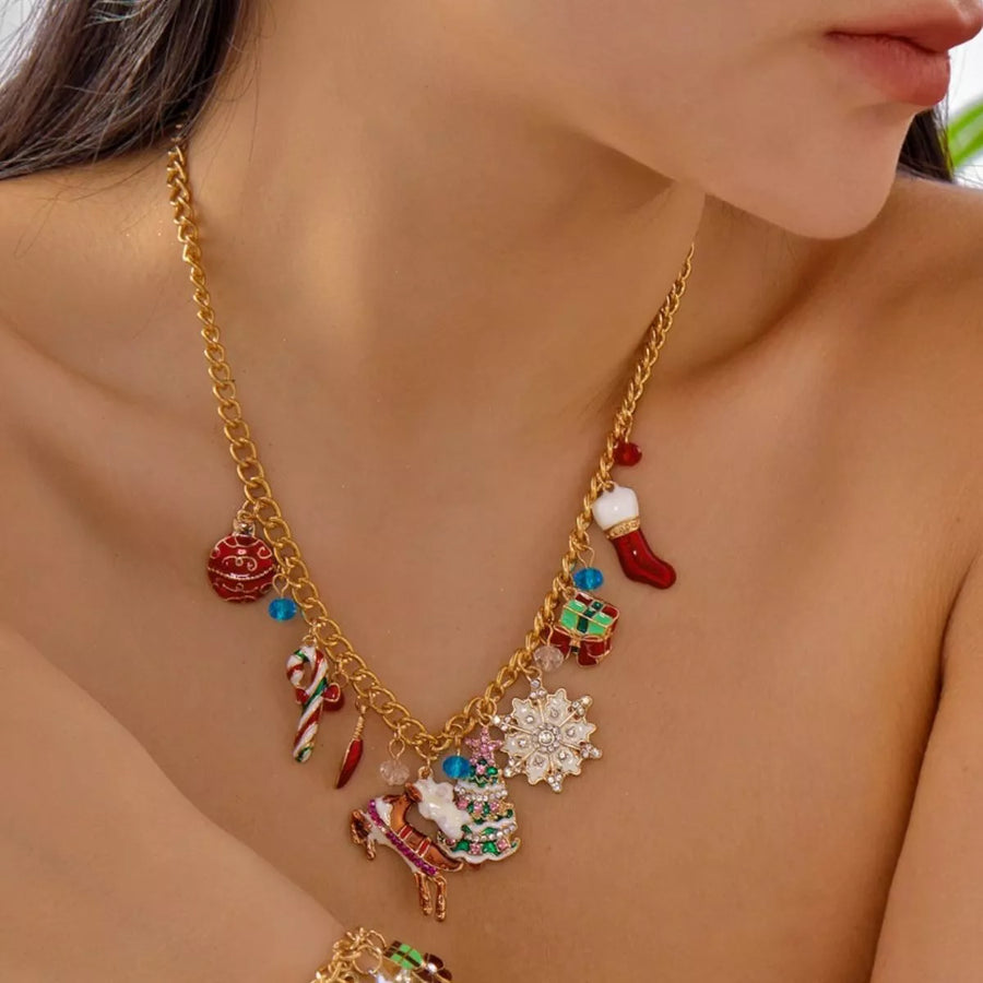 Gold charm necklace with Christmas ornaments, stocking, candy cane, tree, and reindeer.