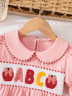 Pink A-line dress featuring smocked and embroidered