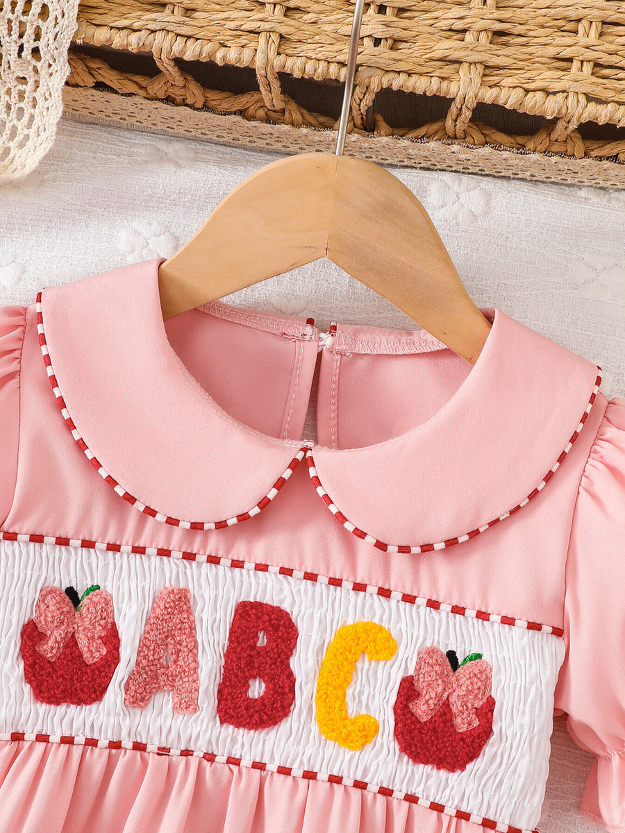 Pink A-line dress featuring smocked and embroidered