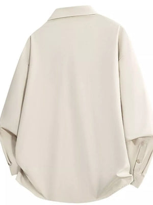 Oversized beige collared shirt with long sleeves and button cuffs