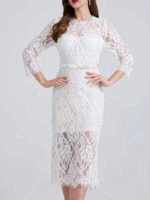 White lace midi dress with sheer sleeves, sweetheart neckline, and white belt.