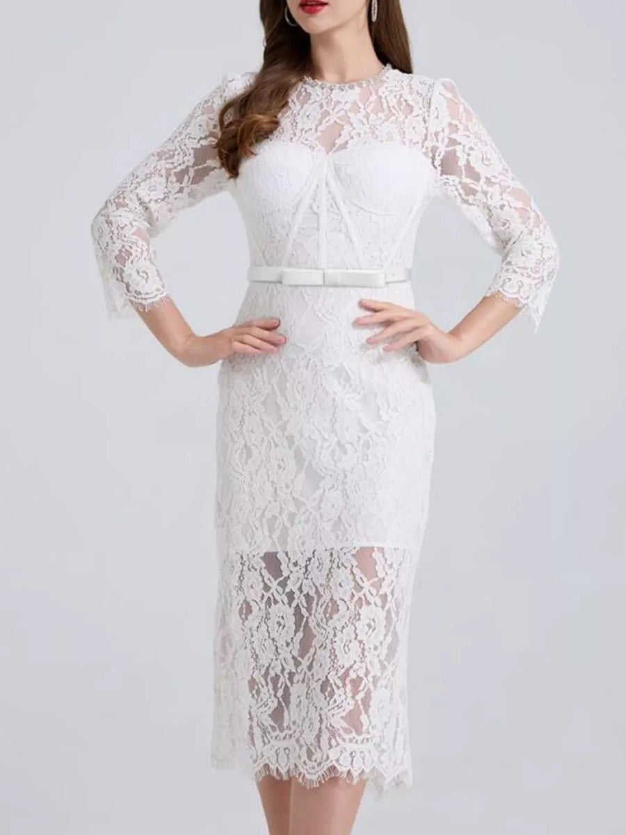 White lace midi dress with sheer sleeves, sweetheart neckline, and white belt.