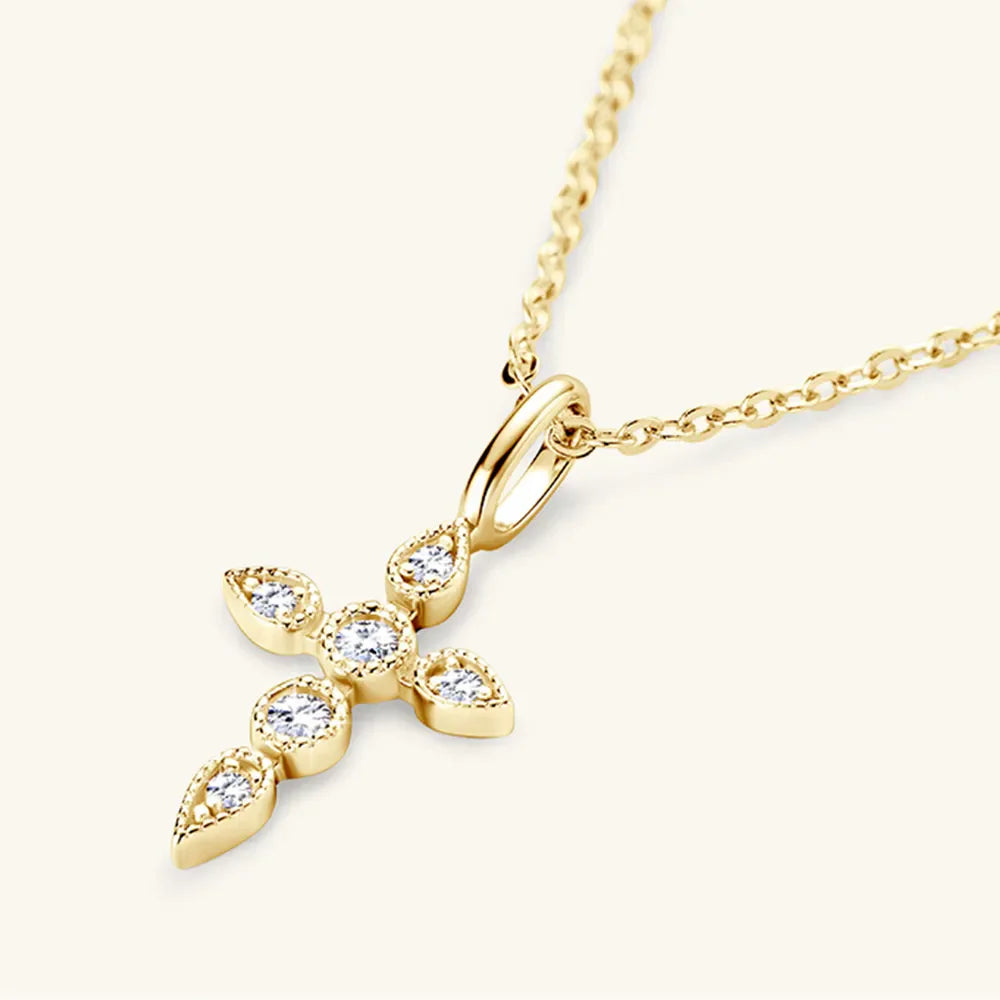 Gold cross pendant necklace with diamonds and delicate chain.