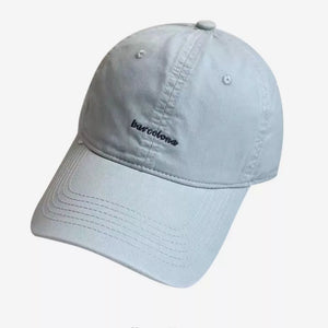 Light blue baseball cap with embroidered "barcelona" text and stitched brim.