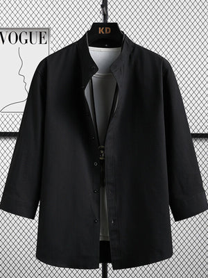 Black textured shirt with mandarin collar and 3/4 sleeves, worn over a white tee.