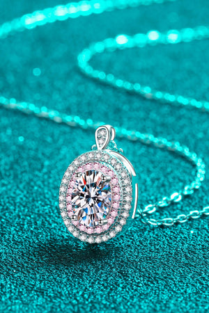 Silver halo pendant necklace with oval moissanite and pink accent stones.