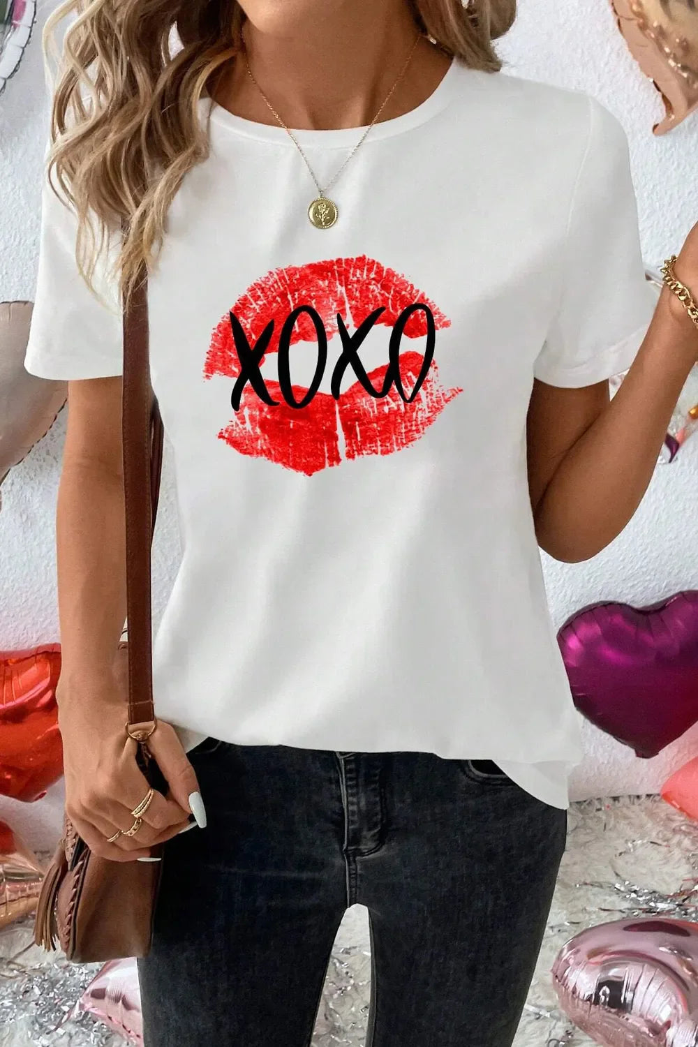 White t-shirt with red XOXO lip graphic print and short sleeves.