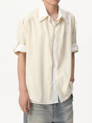 Casual yellow striped button-up shirt with rolled sleeves and a white undershirt.
