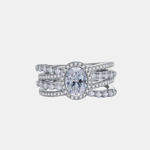 Triple band silver ring with oval moissanite center stone and halo.