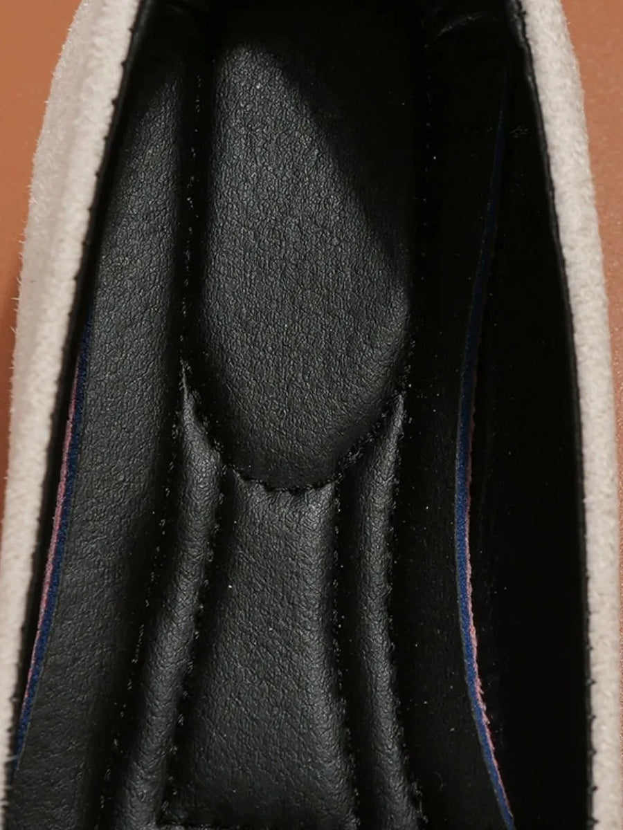 Beige embellished suede ballet flats with padded black insole and striped trim.