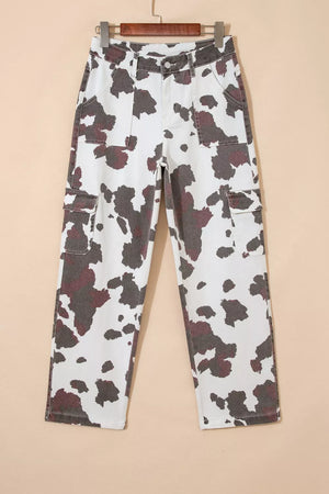 Cow print utility jeans with cargo pockets in a white and brown pattern.